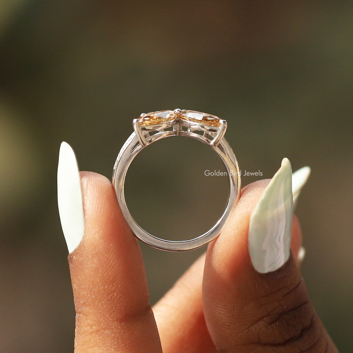 Silver-tone band of butterfly engagement ring with marquise-cut stones, top view