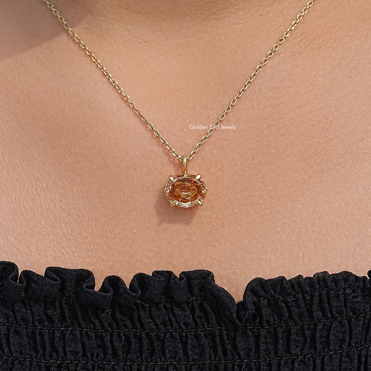 Champagne oval moissanite pendant on gold chain, close-up view