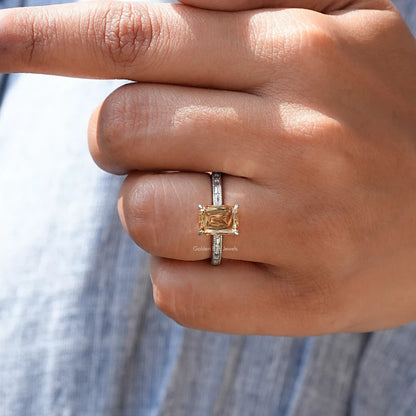Sterling silver ring with square golden center stone and baguette side stones, close-up
