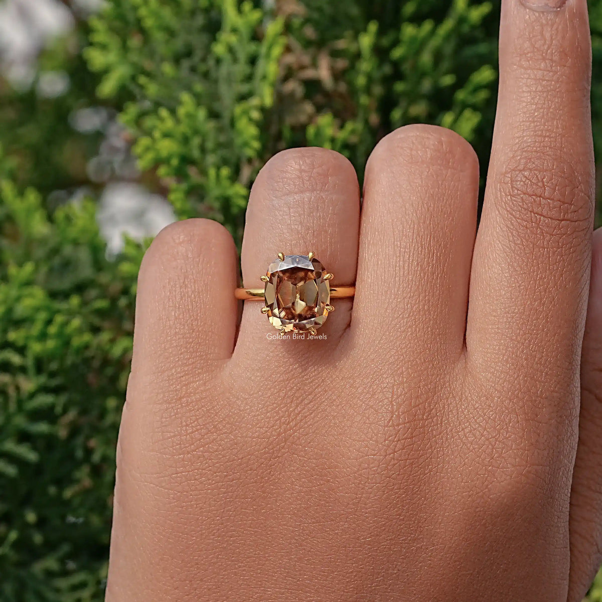 Gold-toned cushion-cut moissanite engagement ring viewed from front
