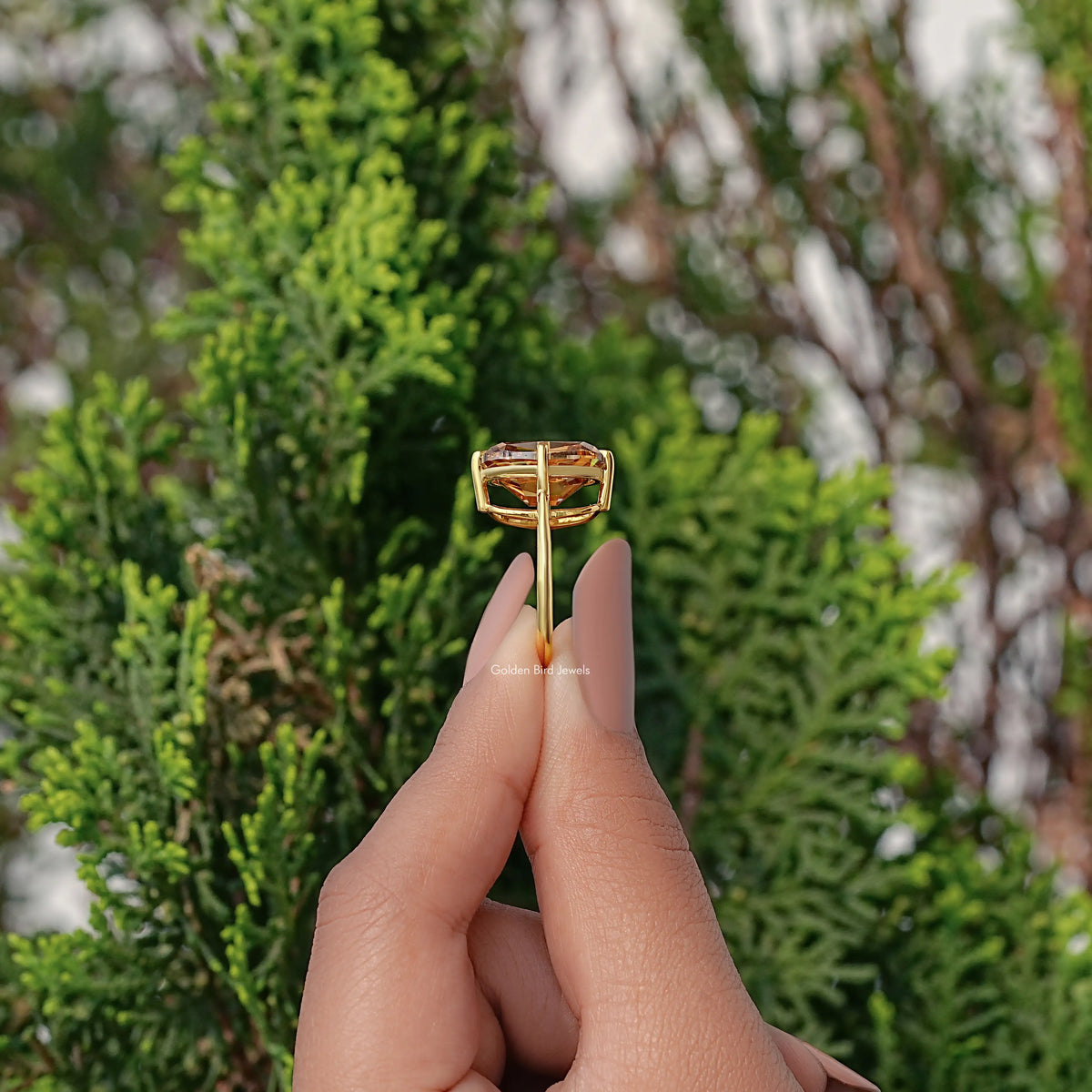 Gold cushion solitaire ring underside view with open basket and prongs