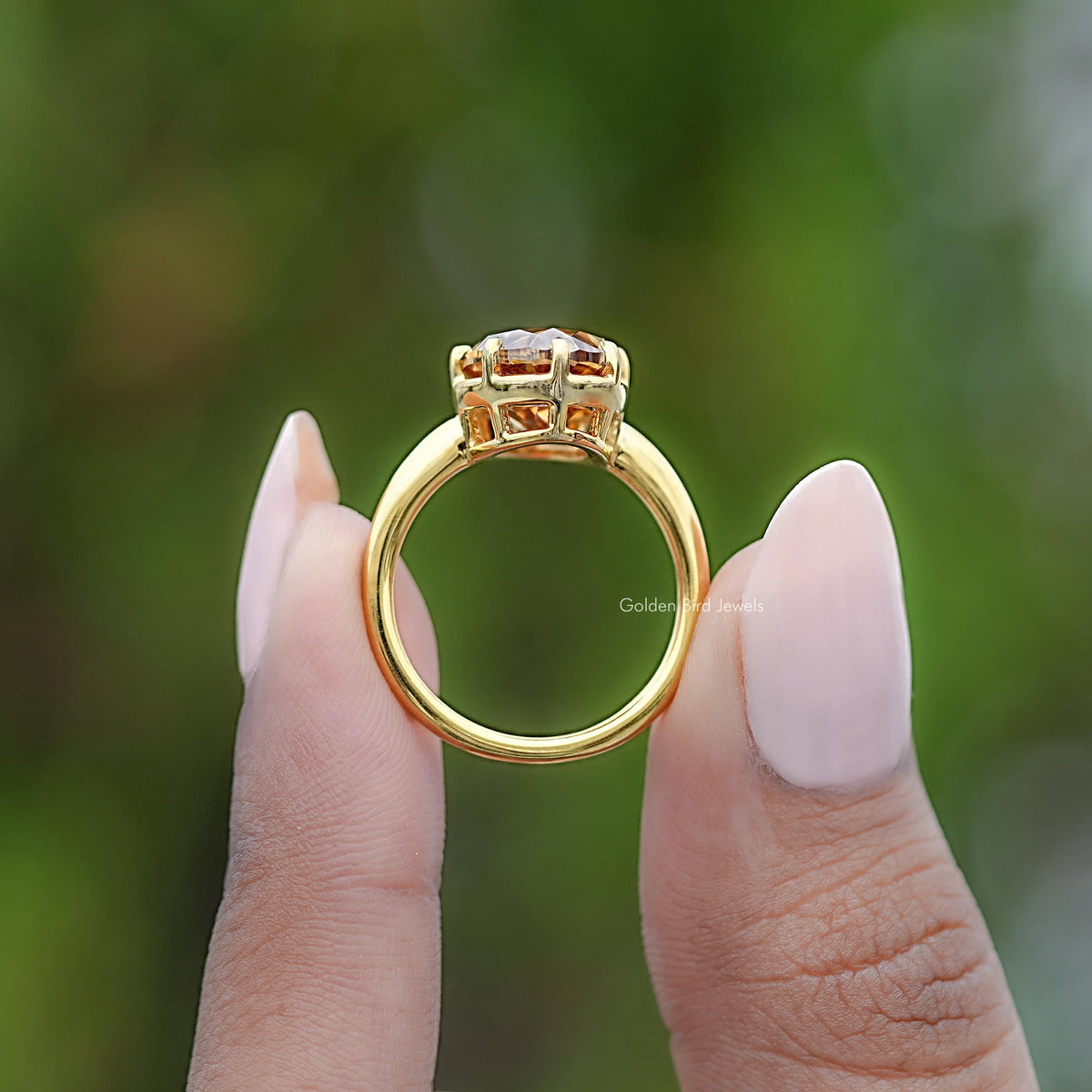 Champagne moissanite solitaire ring, side view in yellow gold setting