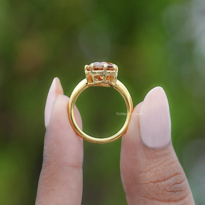 Champagne moissanite solitaire ring, side view in yellow gold setting