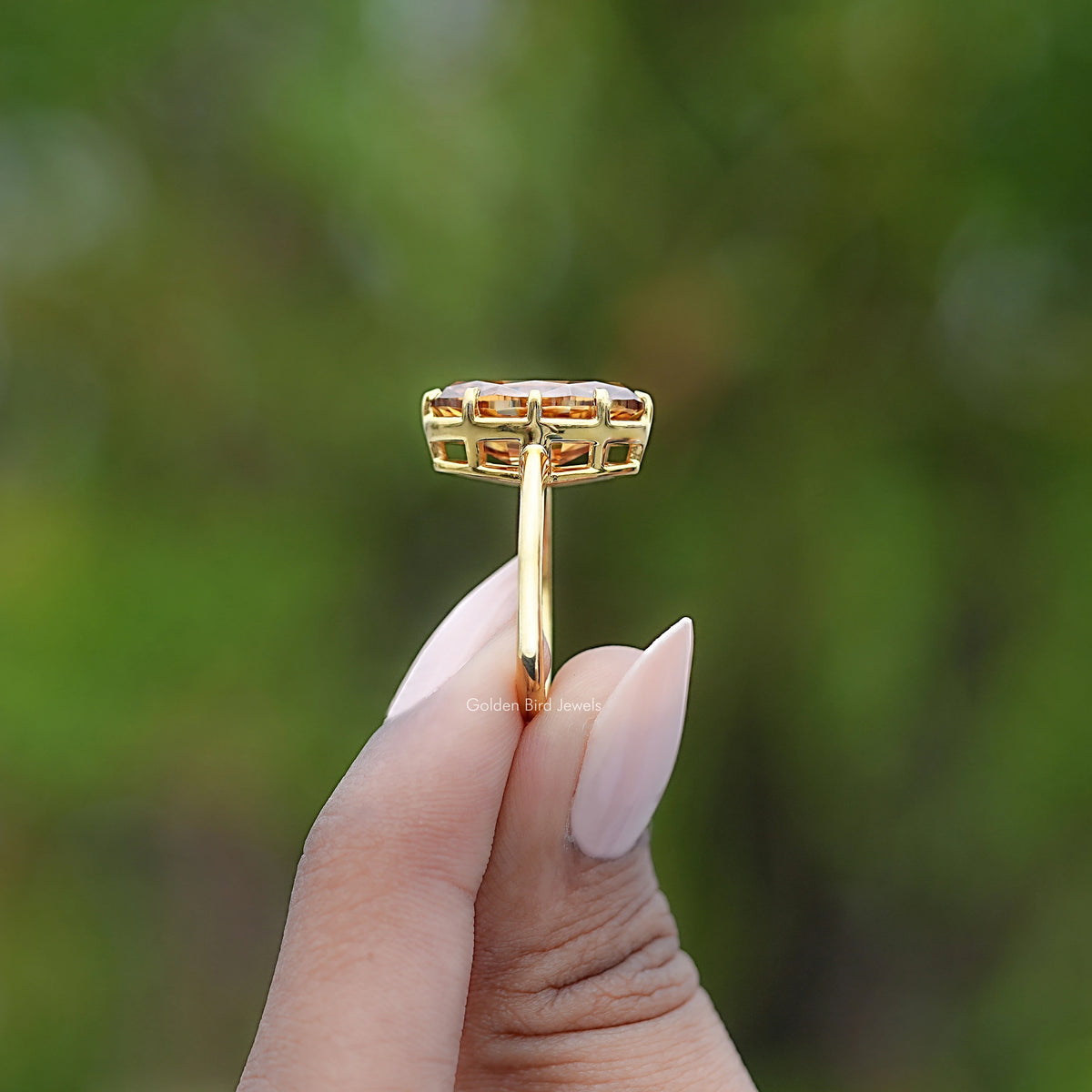 Champagne moissanite solitaire ring, side view in yellow gold setting