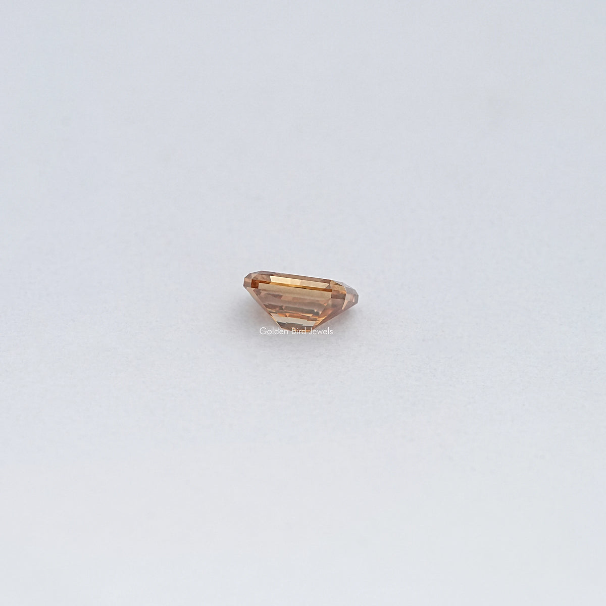 Emerald-cut champagne moissanite loose stone, side profile view