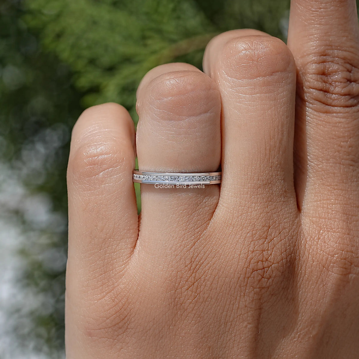 Silver-tone moissanite eternity band with round stones channel-set across the top