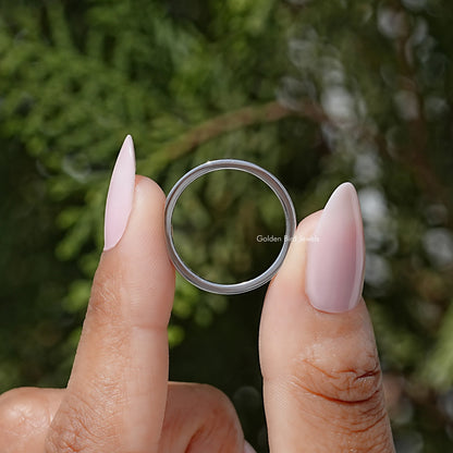 Round-stone channel-set eternity ring shown from the front, silver-tone band