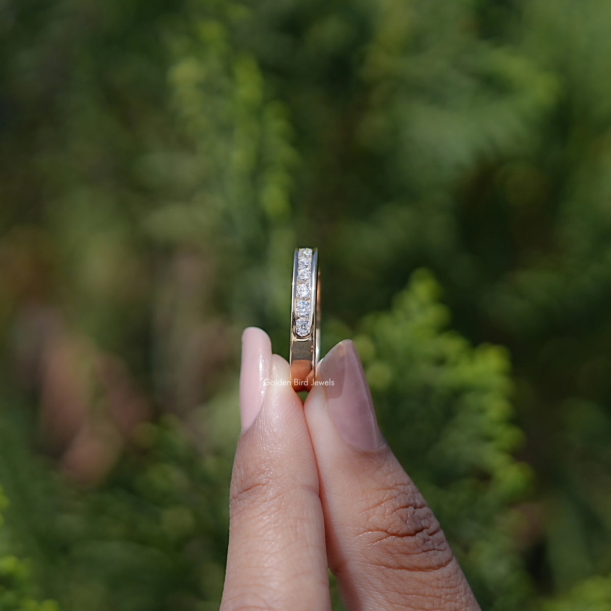 Silver vertical view of half-eternity channel-set ring with round stones