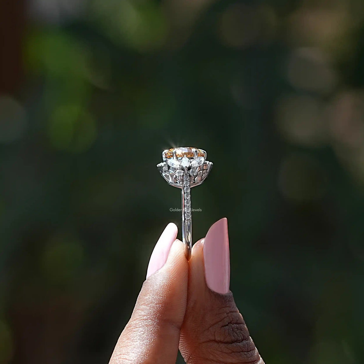 Silver ring with oval halo setting and round center stone on prongs