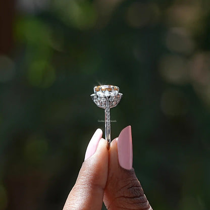 Silver ring with oval halo setting and round center stone on prongs