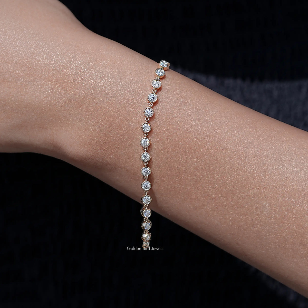 Gold-tone row of round clear gemstones on a delicate bracelet chain