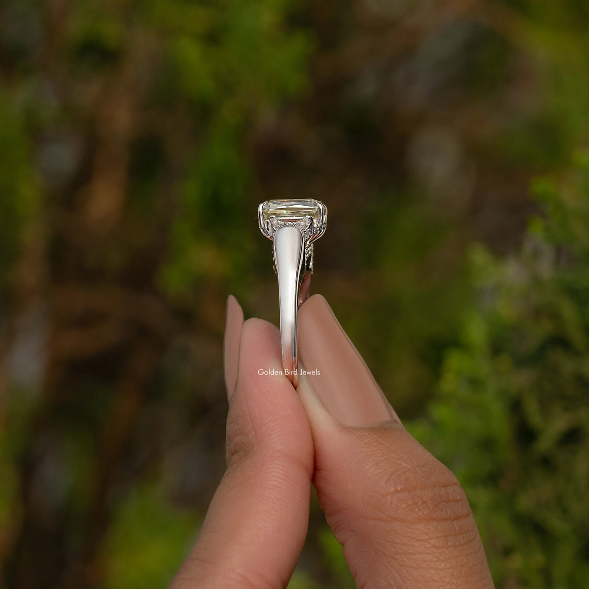 Sterling silver three-stone ring with tall prongs holding square center stone