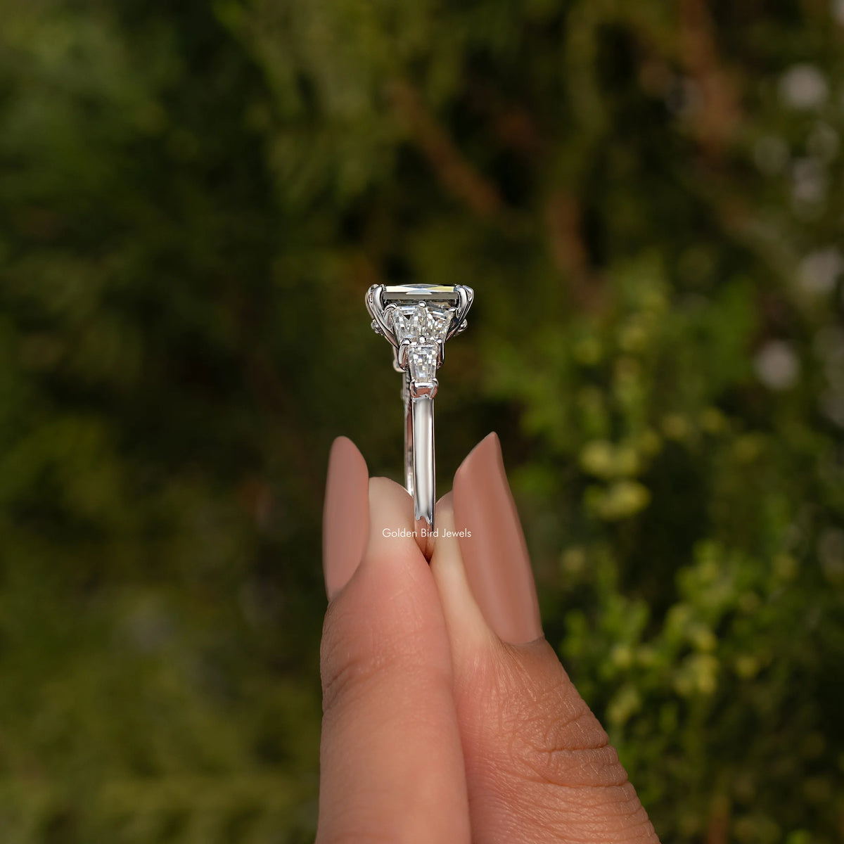 Sterling silver ring profile with raised rectangular center moissanite and prong-set details