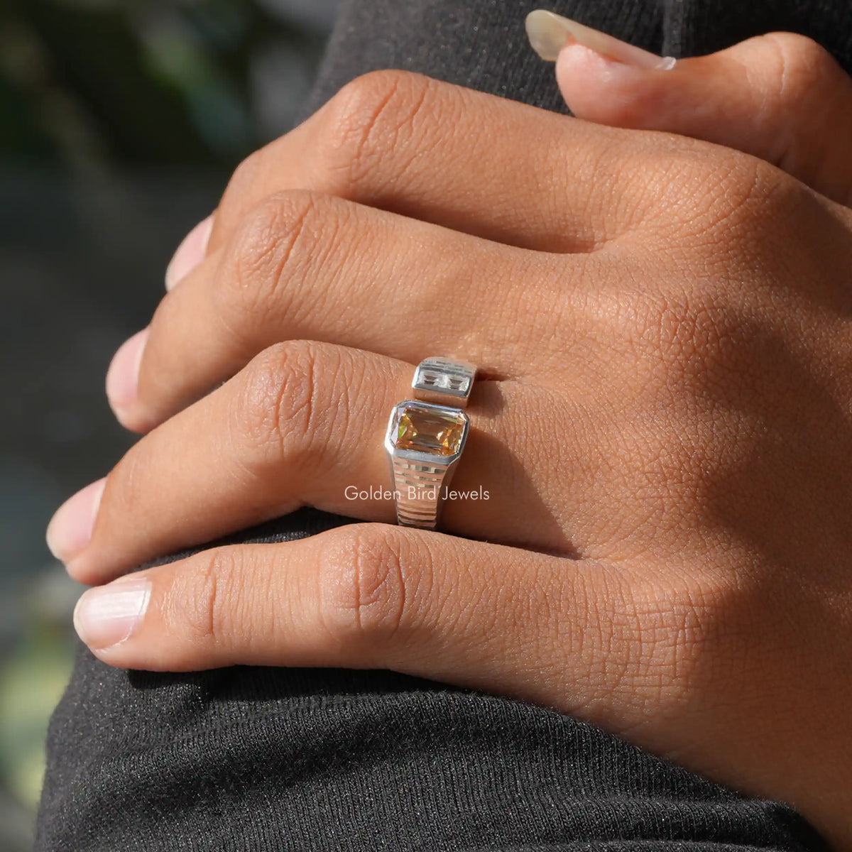 Open cuff ring with square clear center and warm amber stone, split shank on hand