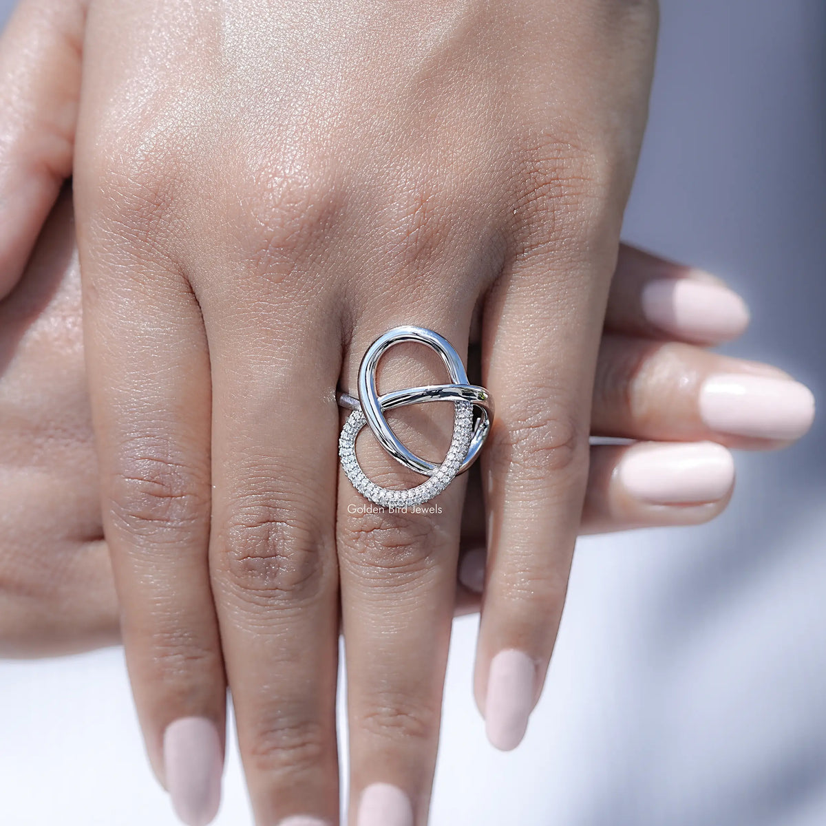 Round cut lab diamond criss-cross loop band on hand