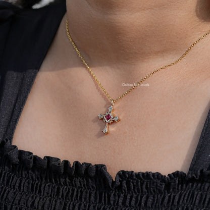 Gemstone cross pendant on gold chain, square red centerpiece with silver accents