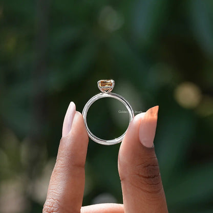Sterling silver ring with raised square golden center stone and open top view