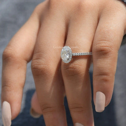 Oval moissanite halo accent ring on a hand