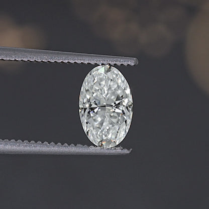 Oval crushed ice moissanite gemstone, clear brilliant facets held by tweezers