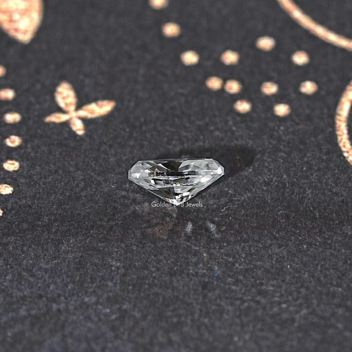 Small oval clear moissanite gemstone with faceted sparkle on dark display