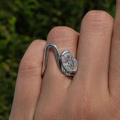 Oval moissanite solitaire ring on hand, curved 925 sterling silver band