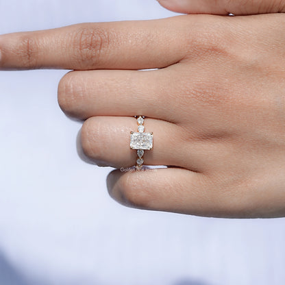 Radiant-cut center stone ring with clustered hidden halo and band.