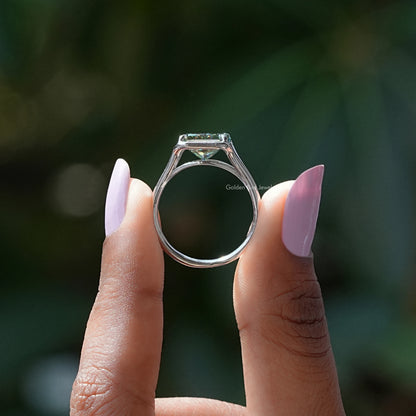 Silver ring band with open-back setting holding an emerald-cut moissanite