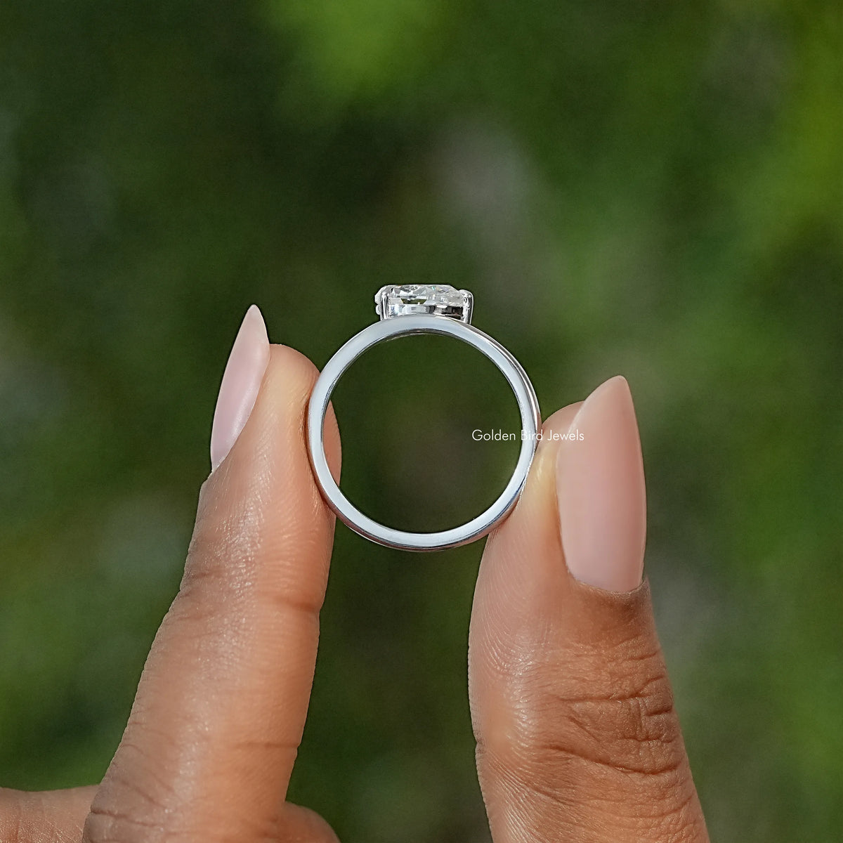 Pear-cut moissanite solitaire engagement ring viewed from the side