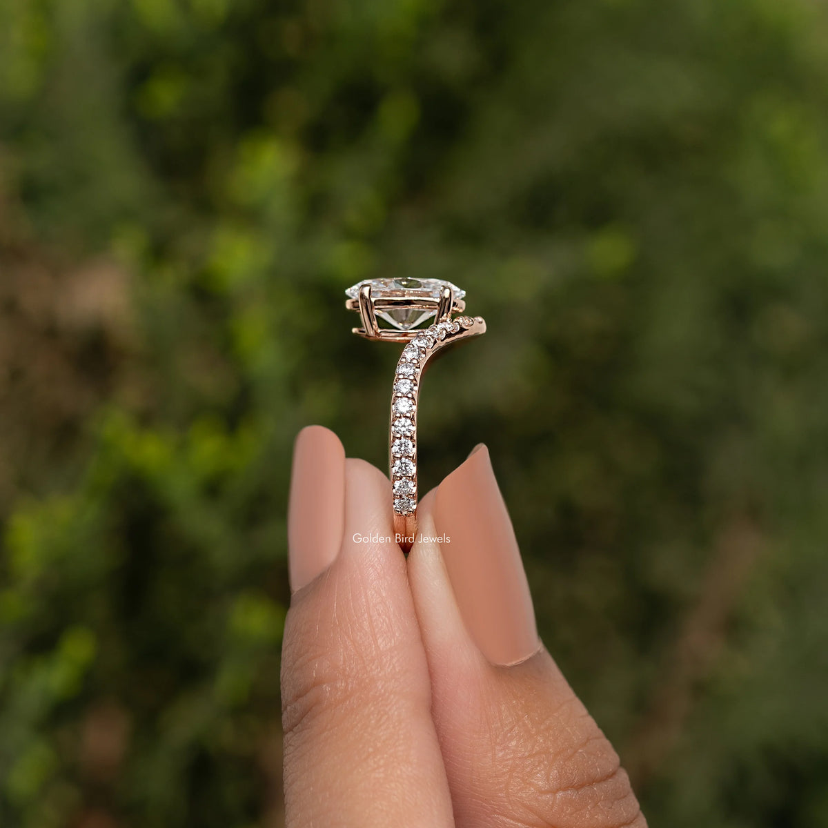 Oval-cut lab diamond ring with curved pavé band in gold tone