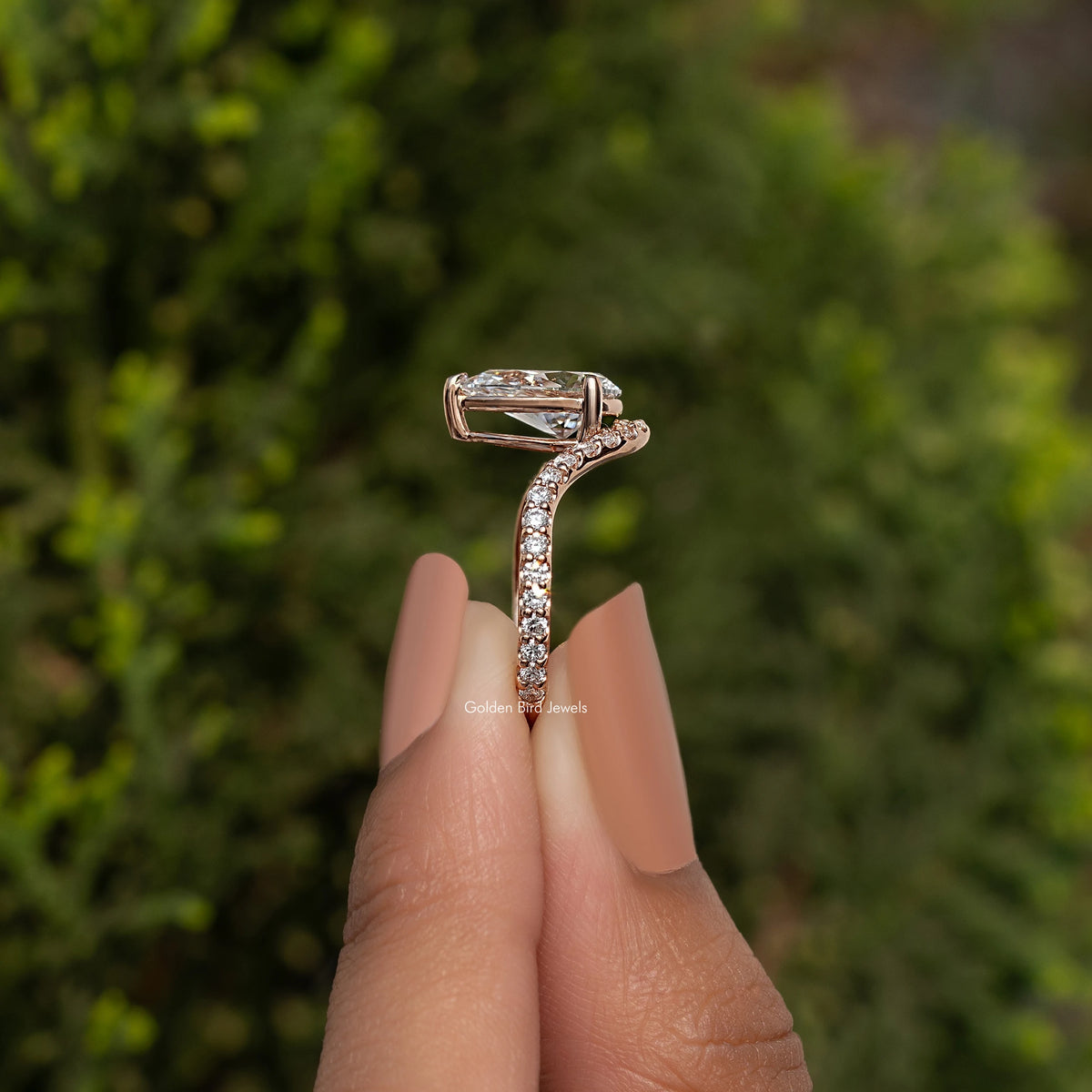 Pear-cut lab grown engagement ring with curved pavé band in rose gold tone