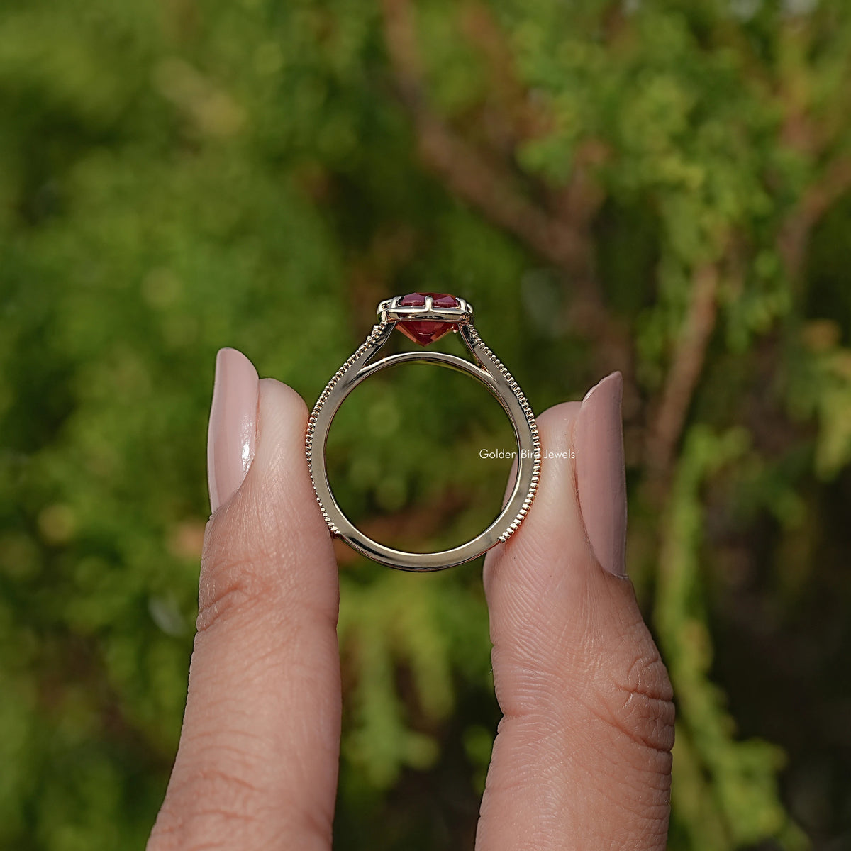 Front view of gold ring with cushion-cut purple gemstone in prong setting