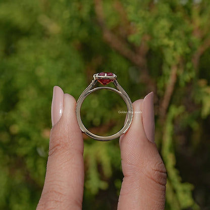 Front view of gold ring with cushion-cut purple gemstone in prong setting