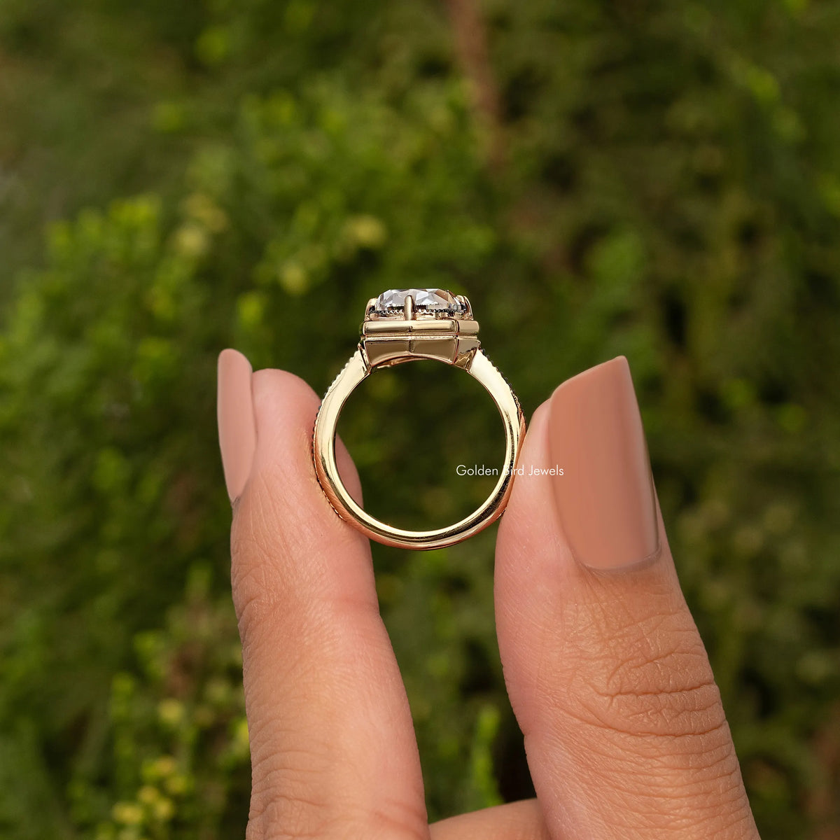 Gold-tone cushion-cut bezel set engagement ring, curved band and open side view