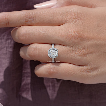 Cushion-cut moissanite halo ring on hand, sterling silver with small side stones