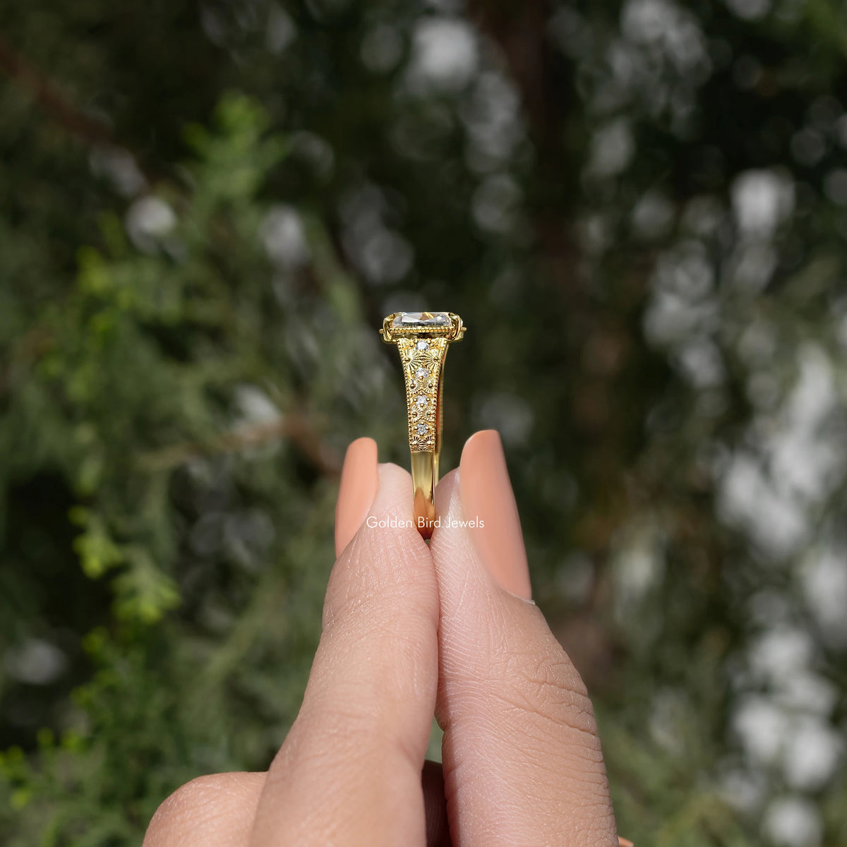 Gold cushion-cut moissanite ring showing top prongs and openwork halo setting