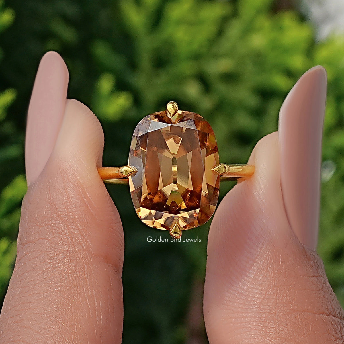 Solitaire cushion-cut moissanite ring with large golden center stone and gold band, front view