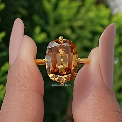 Solitaire cushion-cut moissanite ring with large golden center stone and gold band, front view