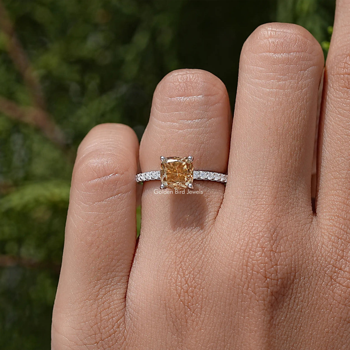 Moissanite engagement ring with cushion-cut center stone and pavé sterling silver band