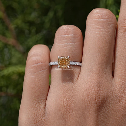 Moissanite engagement ring with cushion-cut center stone and pavé sterling silver band