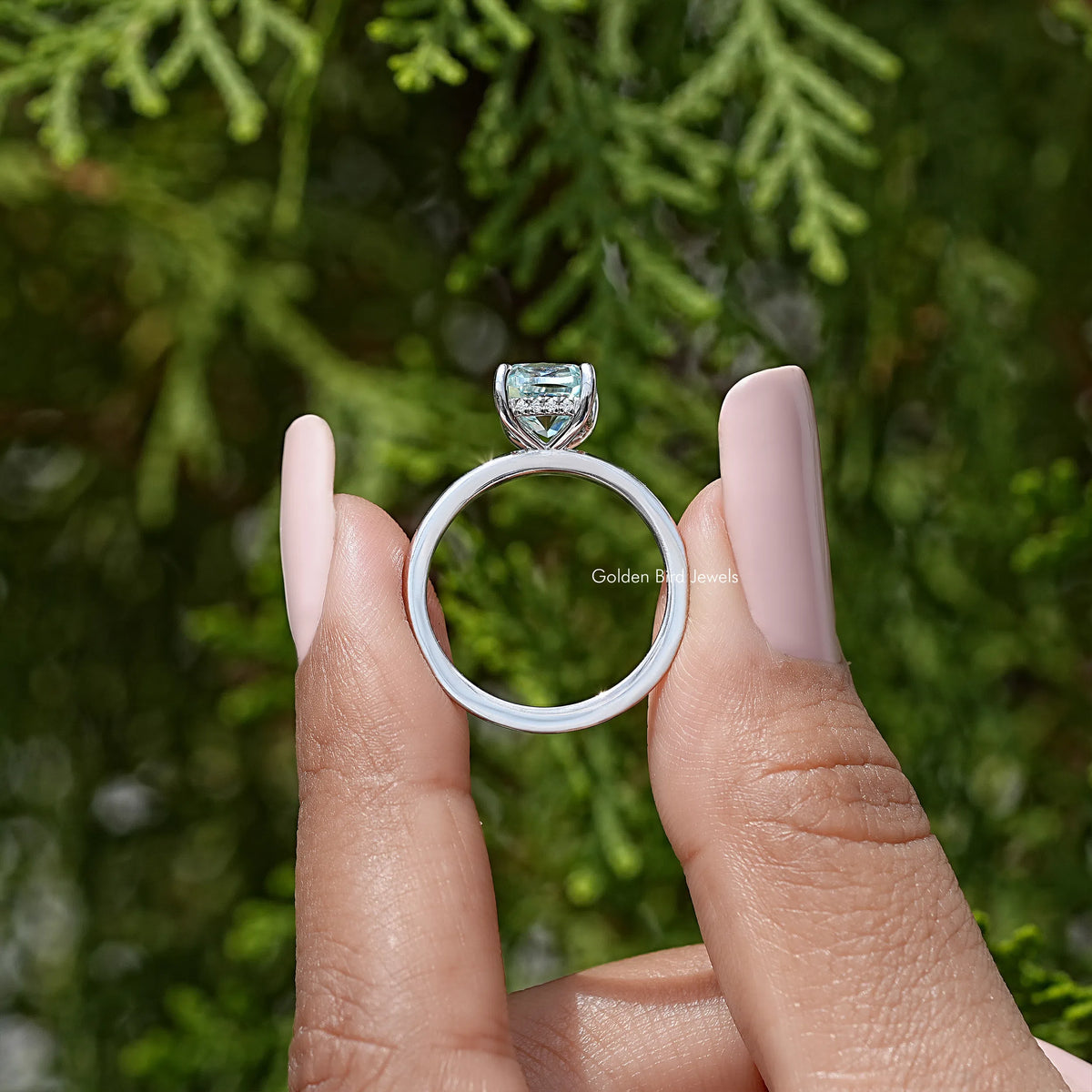 Sterling silver solitaire ring with cushion-cut stone, top view on fingers