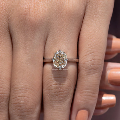 Rose-gold tone elongated cushion-cut solitaire engagement ring with four-prong setting