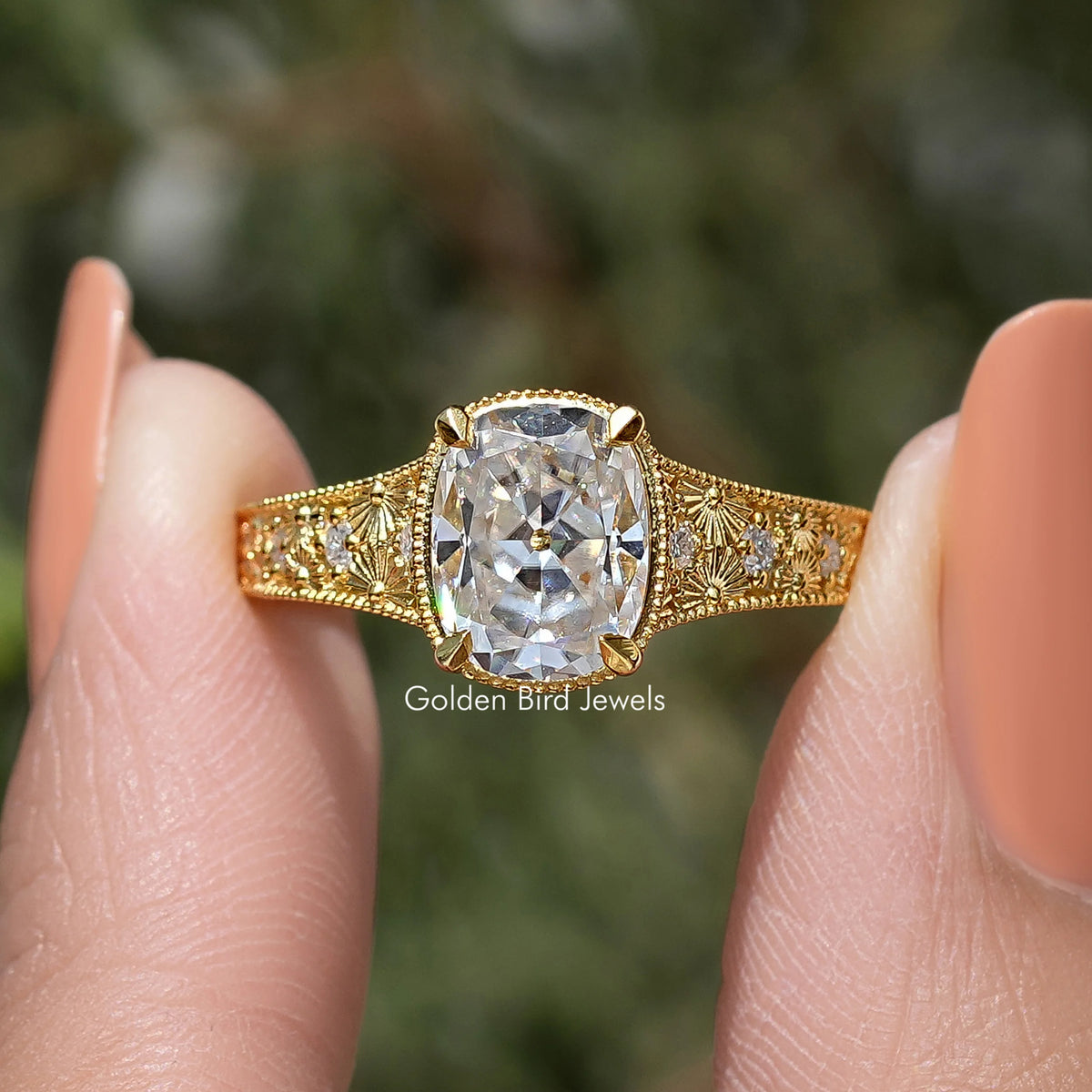 Gold cushion-cut moissanite ring with large center stone and decorative lattice halo