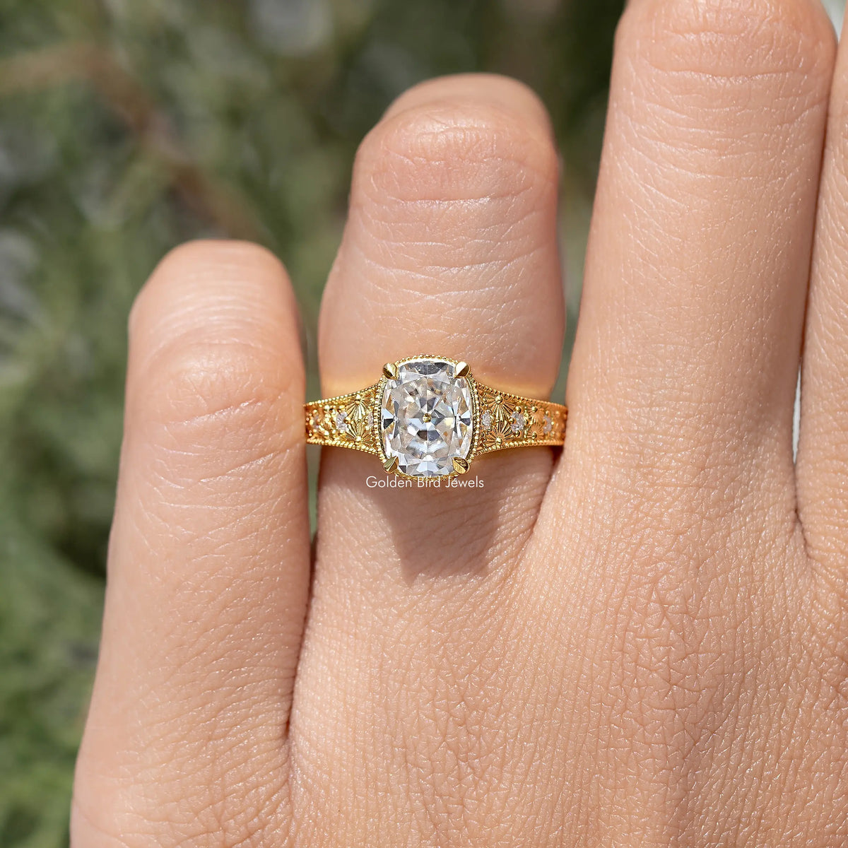 Gold cushion-cut moissanite ring with rectangular halo and textured side pattern
