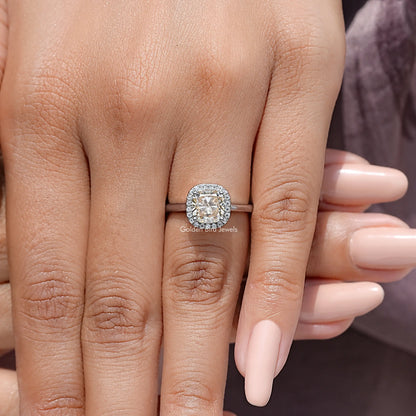 Old mine cushion-cut champagne halo ring on hand, sterling silver band and round sparkle halo