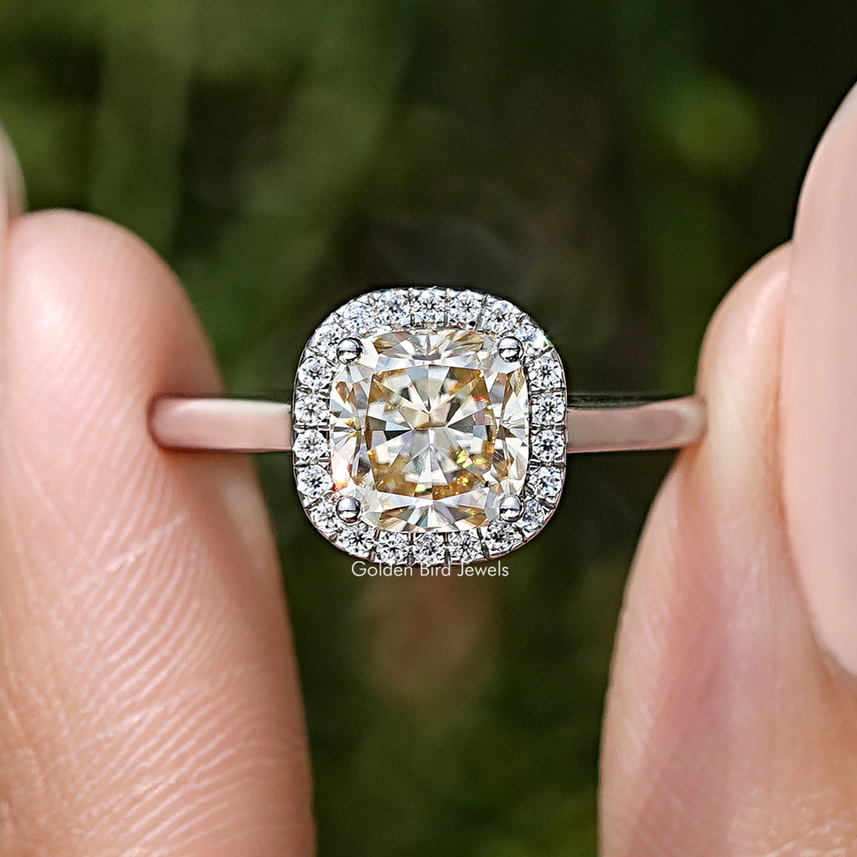 Close-up of sterling silver halo ring with old mine cushion-cut champagne moissanite center