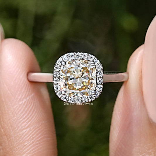 Close-up of sterling silver halo ring with old mine cushion-cut champagne moissanite center