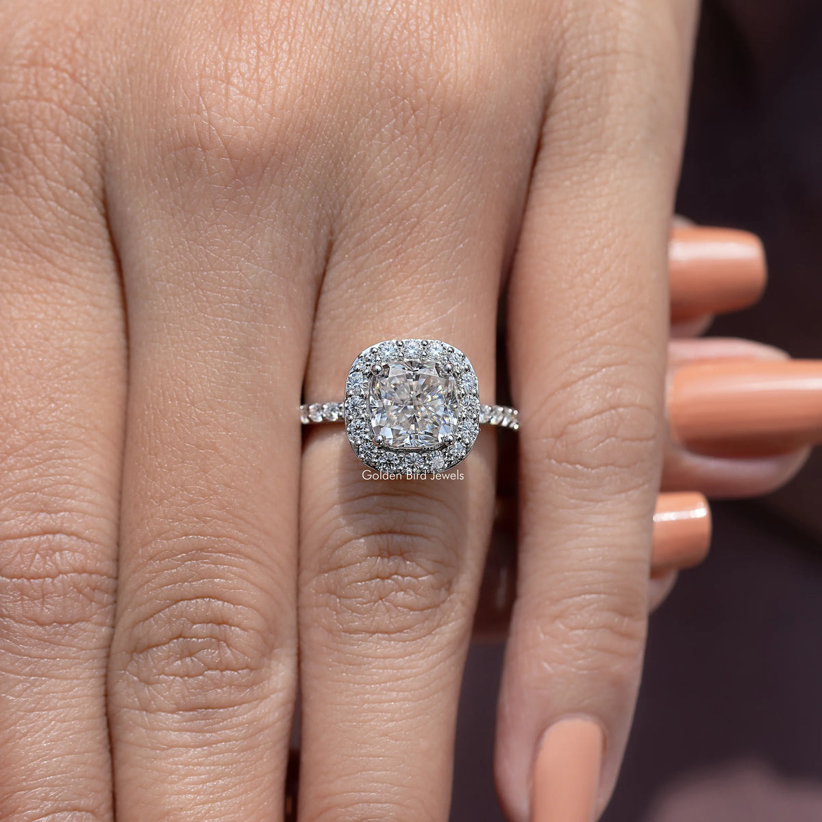 Silver-tone cushion-cut halo engagement ring with raised center stone and thin shank