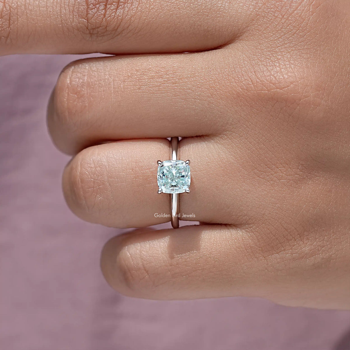 Sterling silver cushion-cut moissanite solitaire ring on hand, side profile