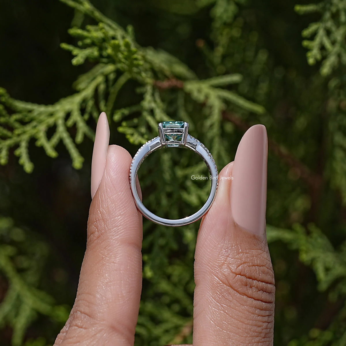 Cushion moissanite engagement ring with twisted accent, side view in silver