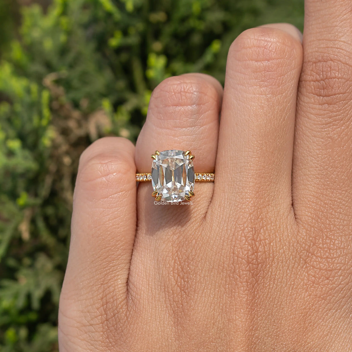 Cushion-cut moissanite accent stone ring on finger